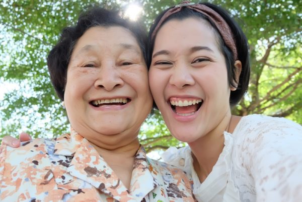 Asian daughter in park with elderly mother