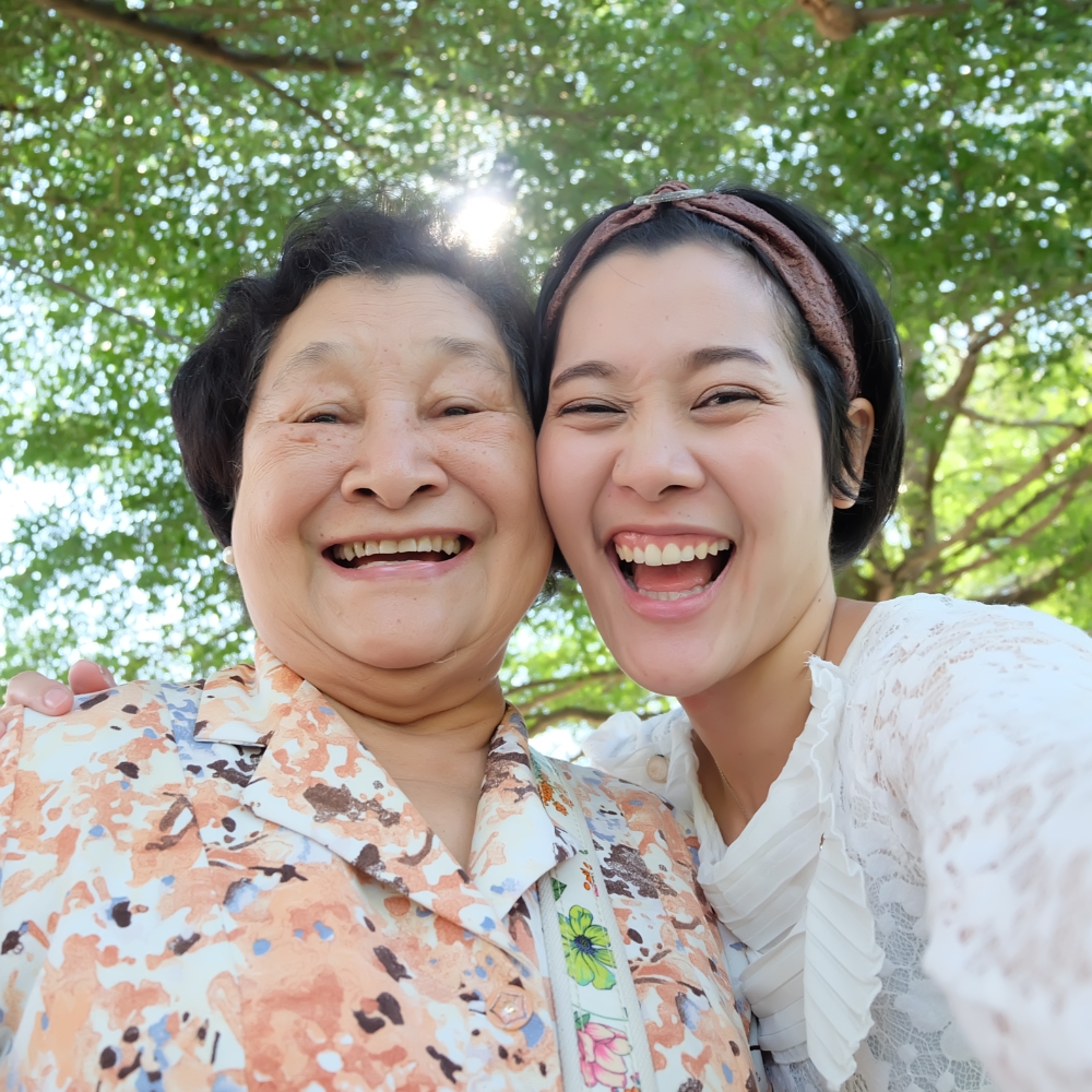 Asian daughter in park with elderly mother